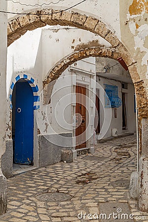 Narrow street with arches in medina of Bizerte Stock Photo