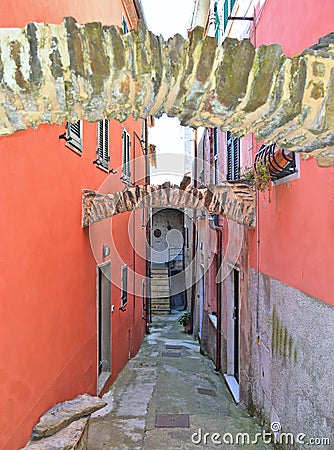 Narrow street and colorful old buildings and stone arches in old small village Montemarcello in Liguria, Italy Stock Photo