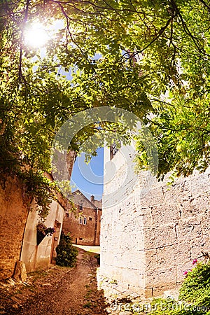 Narrow street in old city Champlitte at sunny day Stock Photo