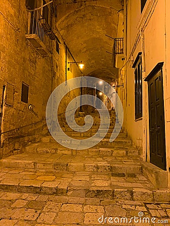 Narrow street at the Sassi of Matera in the night, Matera, Italy Stock Photo