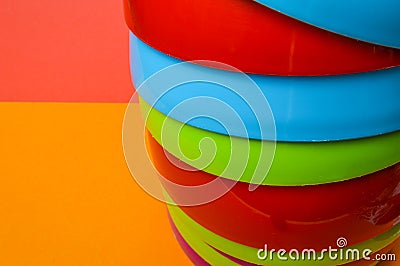 Narrow view of a colorful stack of plastic bowls - abstract colorful background Stock Photo