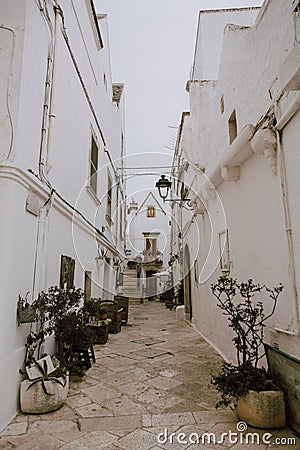 Narrow white street in Locorotondo oldtown, province Bari, Sauthern Italy Stock Photo