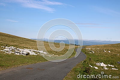 Narrow winding country road over moorland, Cumbria Stock Photo