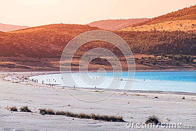 Zoom view of the white sandy beach with grass bushes on the famous lake Salda in Turkey. Wonders of nature and turkish Stock Photo