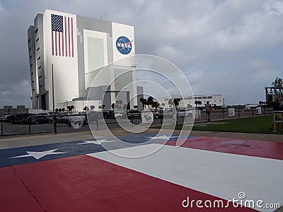 NASA Vehicle Assembly Building and US Flag Editorial Stock Photo