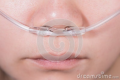 Nasal cannula for oxygen delivery on a woman patient Stock Photo