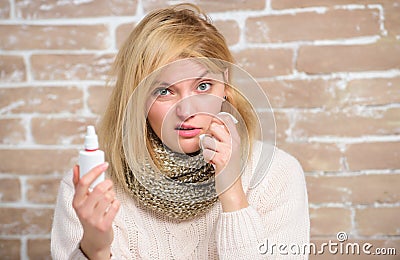 Nasal spray runny nose remedy. Girl sick person hold nasal drops and tissue. Allergy concept. Home treatment. Effective Stock Photo