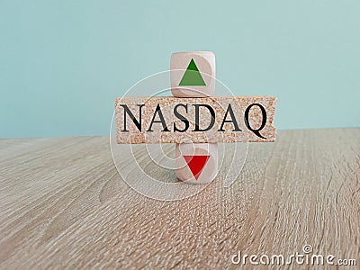 NASDAQ price symbol. A brick block with arrow symbolizing that composite index price are going down or up Stock Photo