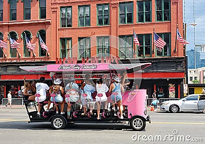 Nashville, Tennessee, U.S - June 26, 2022 - Passengers on the pink color of Music City Crawler moving along the bars and Editorial Stock Photo