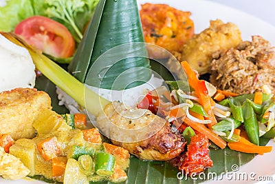 Nasi Campur Bali served on a banana leaf Stock Photo