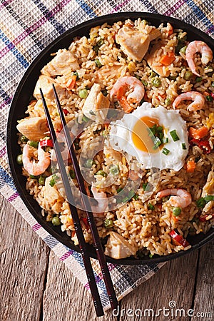 Nasi goreng with chicken, shrimp and vegetables closeup vertica Stock Photo
