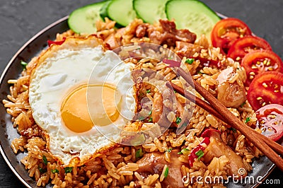 Nasi Goreng - Indonesian Chicken Fried Rice on black plate. Indonesian cuisine dish. Balinese Food. Asian meal Stock Photo