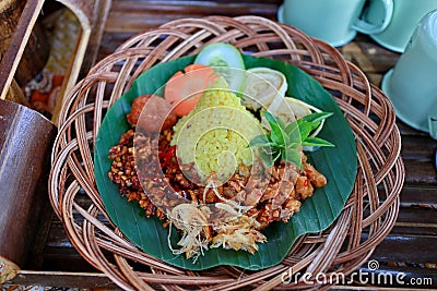 Nasi Kuning. Javanese turmeric rice with assorted side dishes Stock Photo