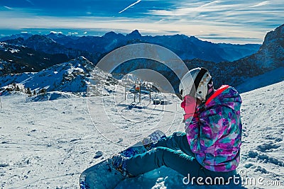 Nassfeld - A snowboarder taking a break on the slope Stock Photo