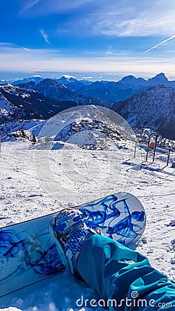 Nassfeld - A snowboarder taking a break on the slope Stock Photo