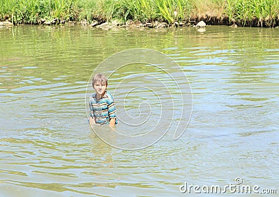 Nasty boy standing in water Stock Photo