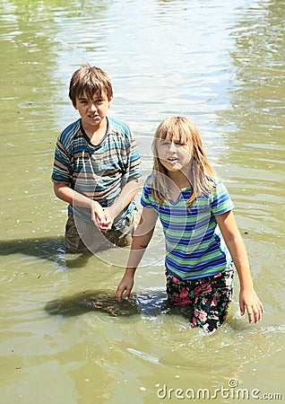 Nasty kids in clothes soaking wet in water Stock Photo