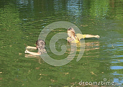 Nasty kids in clothes soaking wet in water Stock Photo