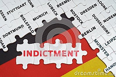 On the flag of Germany there are puzzles with the names of cities and puzzles with the inscription - Indictment Stock Photo