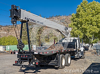 A National Crane 800D mounted on a stand-up boom truck parked at a power plant near Fall River Mills, California - October 31 2022 Editorial Stock Photo