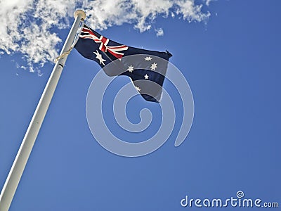 National flag of Australia consists of Union Jack and Southern Cross stars constellation in blue sky sunny day with white cloud Stock Photo