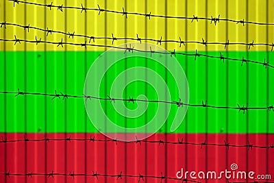 National flag of Myanmar Burma on fence. Stock Photo