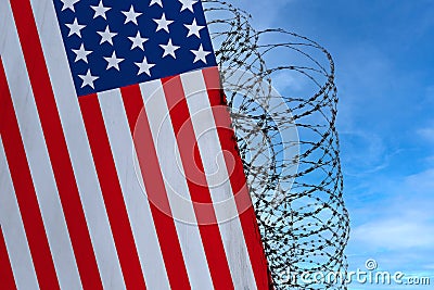 National flag of USA on concrete wall, barbed wire fence, concept of prison, symbol of police state, territory border, Stock Photo