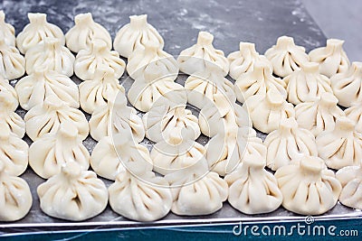 National Georgian cuisine Khinkali metal background Cook prepares khinkali kitchen Top view raw meat dough dish uncooked Street fo Stock Photo