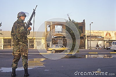 National Guardsman patrolling in front of burned business after 1992 riots, South Central Los Angeles, California Editorial Stock Photo