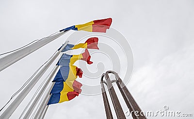 National Heroes Memorial Monument in Carol Park from Bucharest - wide view in a cloudy day with Romanian flags in foreground Editorial Stock Photo