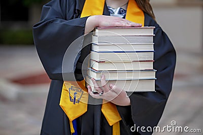National Honor Society Graduate with Stack of Books Stock Photo