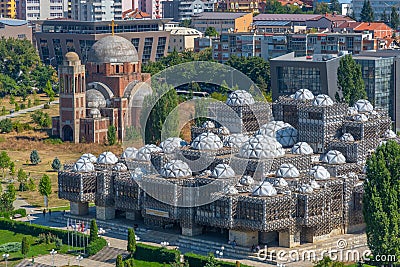 National library of Kosovo and unfinished serbian orthodox church of Christ the Saviour in Prishtina, Kosovo Stock Photo