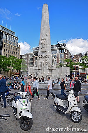 National Monument on Dam Square with motorcycles and heavy crowd Editorial Stock Photo