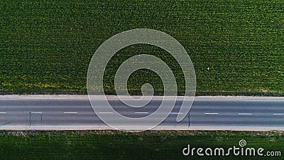 National road seen from drone, green fields around Stock Photo