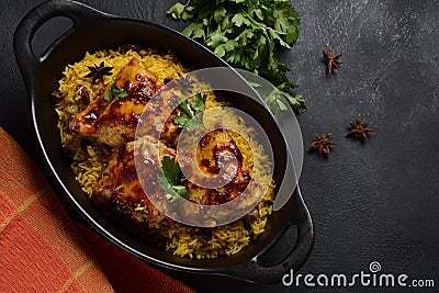 The national Saudi Arabian dish chicken kabsa with roasted chicken quarter and almonds, raisins, garlic and biryani rice Stock Photo