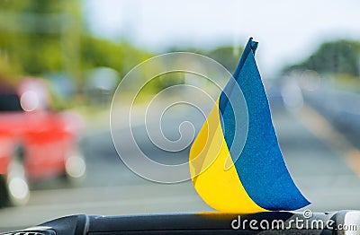 National symbol. Blue-yellow flag of Ukraine. Patriotic sign on glass inside the car Stock Photo