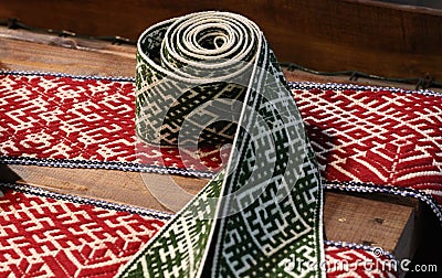 National symbols of Latvia. Closeup of Lielvarde belt stock photo. Latvian folk costumes belt. Red and grey Stock Photo