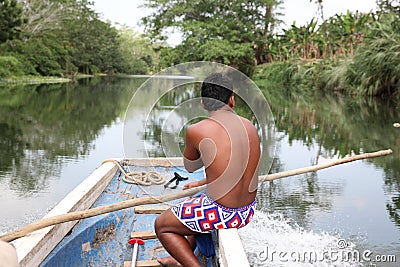 Native american (indian) man on a boat on a river. Indian man. Editorial Stock Photo