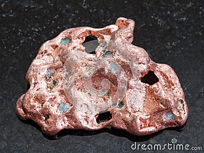 Native copper stone on dark granite background Stock Photo