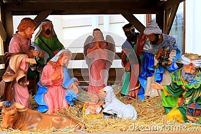 Nativity of Jesus Christ, nativity scene near church. Virgin Mary, Saint Joseph, baby Jesus, angels and animals. Christmas and New Stock Photo