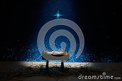 Nativity of Jesus, empty manger at night with bright lights. Stock Photo