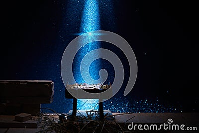 Nativity of Jesus, empty manger at night with bright lights. Stock Photo