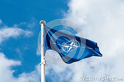 NATO flag waving in the wind Stock Photo