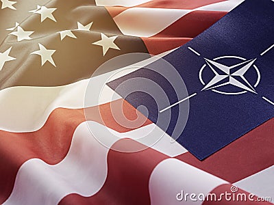 NATO symbol on the background of the American flag. Organization of the North Atlantic Treaty. Editorial Stock Photo