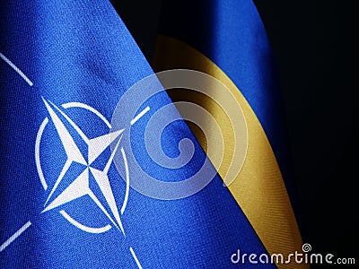 NATO and Ukraine flags as symbol of cooperation Stock Photo