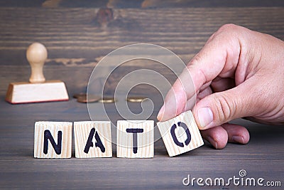 Nato from wooden letters on wooden background Stock Photo