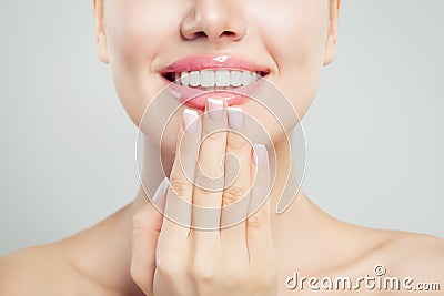 Natural beauty concept. Closeup female smile with natural pink lips and french manicure hand Stock Photo