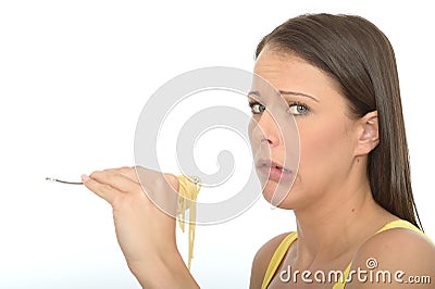 Natural Cautious Young Woman Holding A fork Full of Cooked Spaghetti Pasta Stock Photo