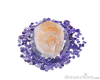 Natural citrine point surrounded by amethyst small tumbled chips Stock Photo