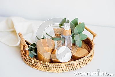 Natural cosmetics set in eco-friendly packaging in rattan tray with eucalyptus and towel. SPA, bath beauty products Stock Photo